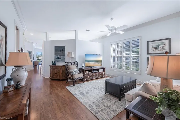 Family room featuring crown molding, ceiling fan, and Laminate floors