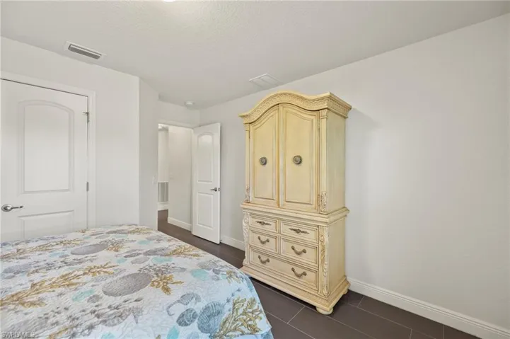 Bedroom featuring baseboards and a textured ceiling