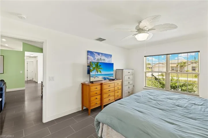 Bedroom with baseboards and a ceiling fan