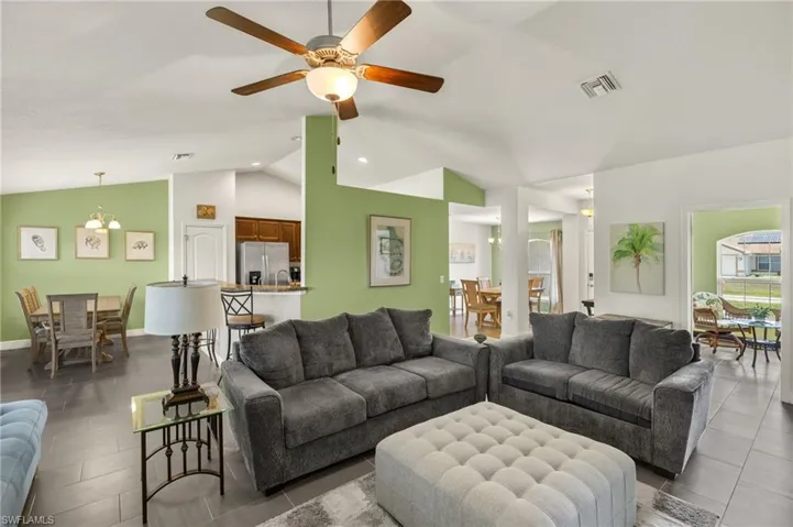 Living area with lofted ceiling and ceiling fan