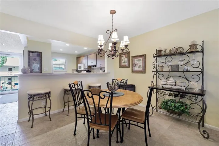 Dining room featuring a chandelier, baseboards, and recessed lighting