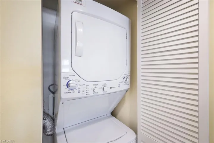 Laundry area with stacked washer and clothes dryer and laundry area