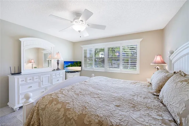Bedroom featuring ceiling fan and a textured ceiling