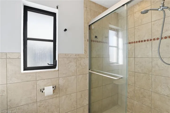 Bathroom featuring a stall shower and healthy amount of natural light