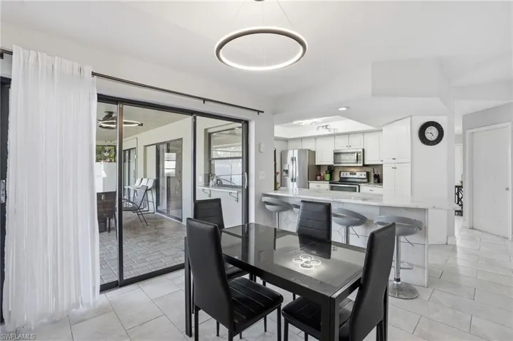 Dining space featuring light tile patterned floors