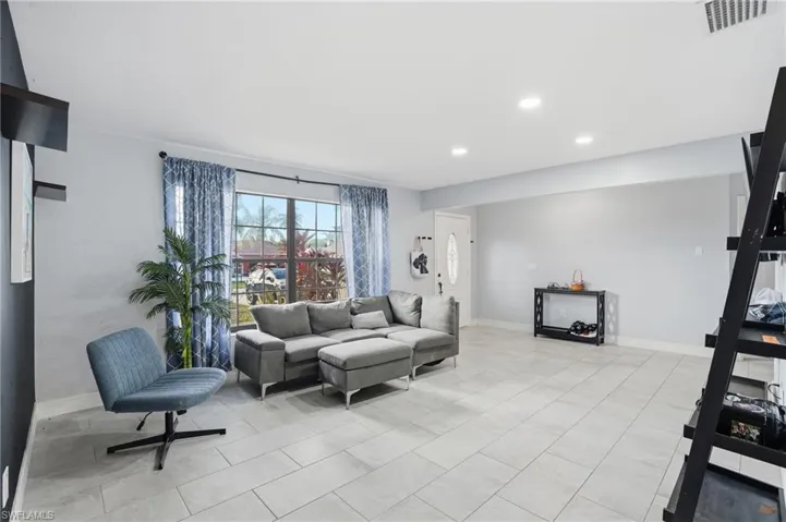 Living area with baseboards and recessed lighting