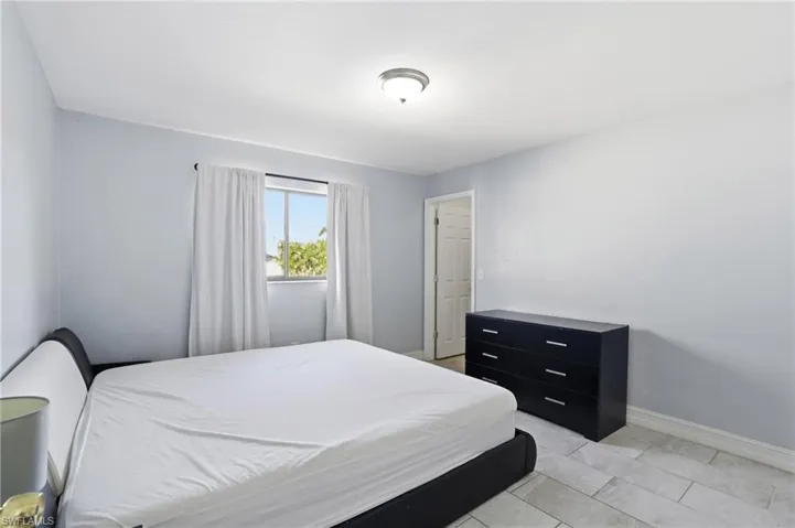 Bedroom with light tile patterned floors