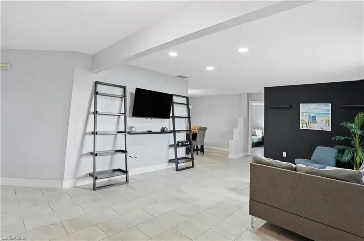 Living area with recessed lighting and baseboards