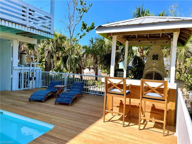 Spacious outdoor deck featuring an integrated swimming pool, a built-in outdoor bar.