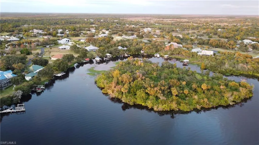 Aerial view of property's location with a large body of water