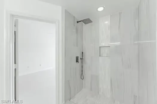 Bathroom featuring a marble finish shower