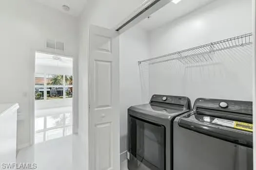 Washroom featuring washer and dryer and ceiling fan