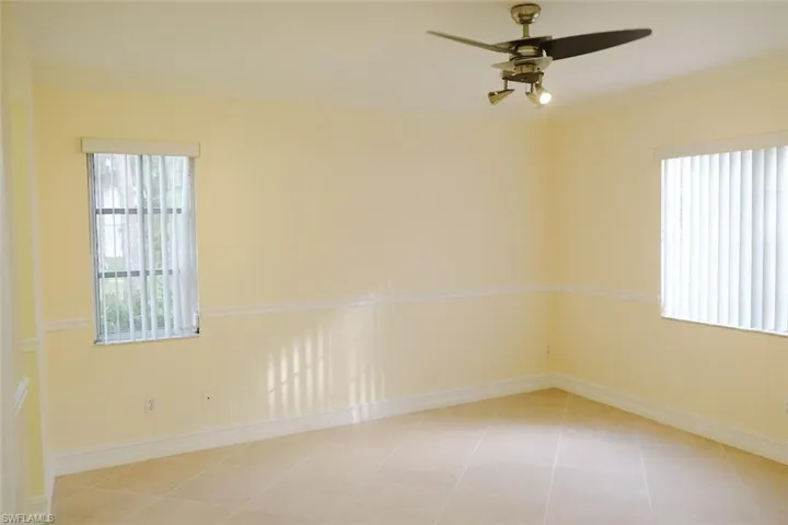 Unfurnished room with ceiling fan and light tile patterned flooring