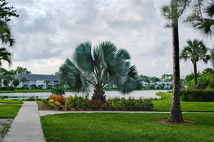 View of community with a lawn and a water view