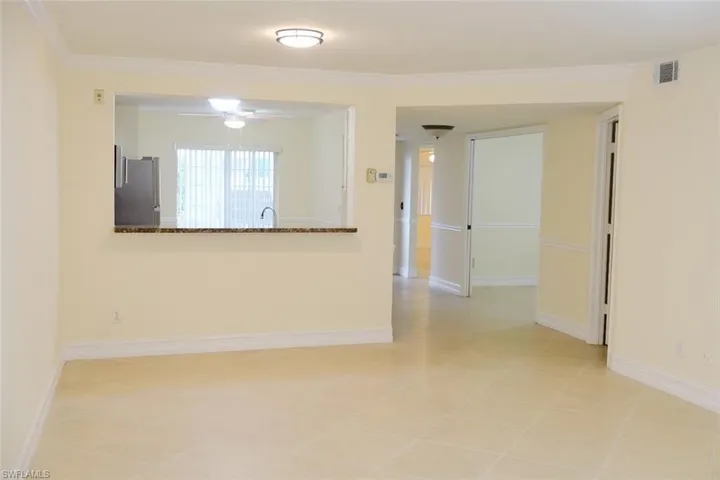 Tiled empty room featuring ceiling fan