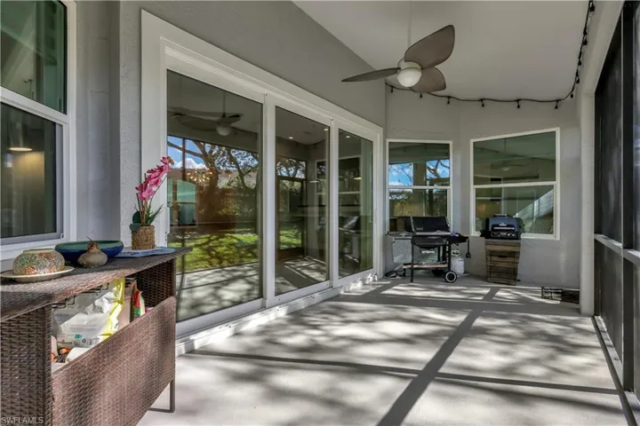 Sunroom / solarium with a ceiling fan and a patio area