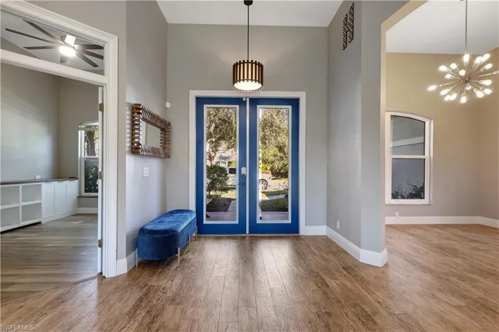 Entryway featuring a chandelier, wood finished floors, and french doors