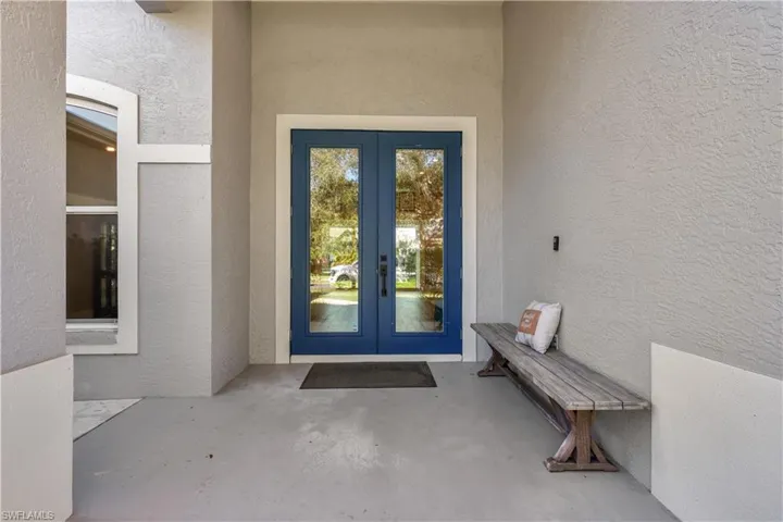Doorway to property with stucco siding, french doors, and a patio