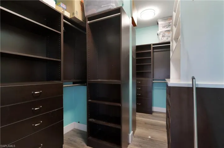 Walk in closet featuring light wood-style flooring