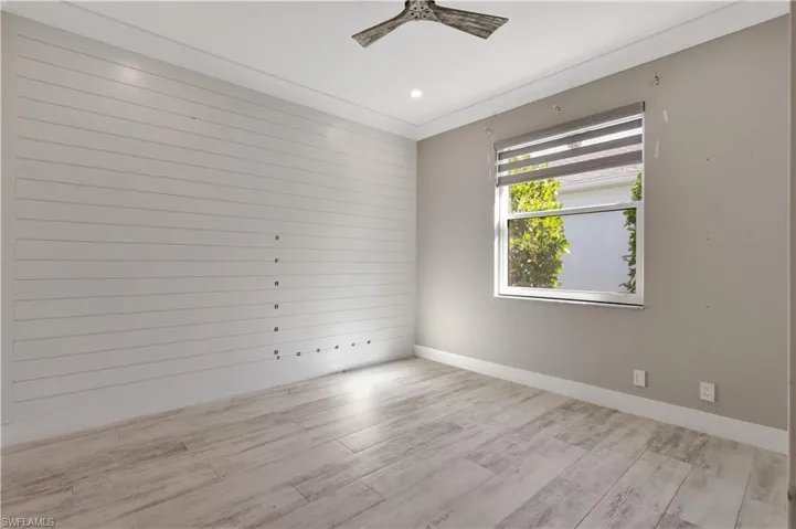 Empty room with light wood-type flooring, a ceiling fan, and recessed lighting