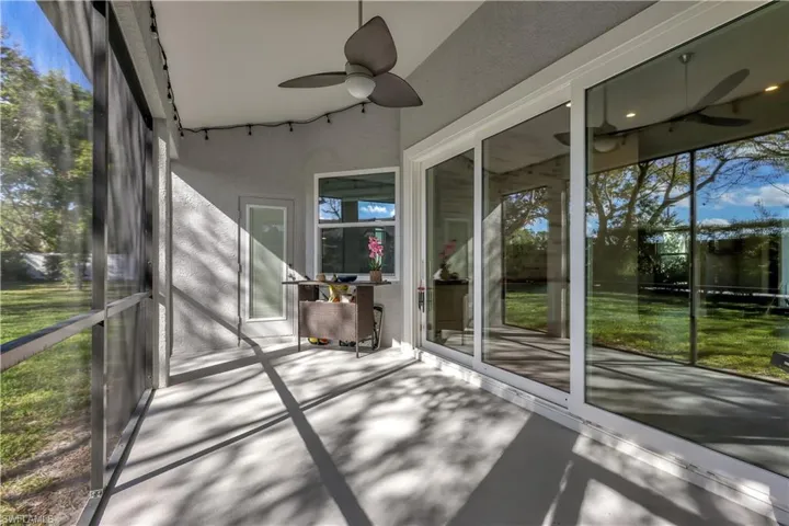 Unfurnished sunroom with a ceiling fan and healthy amount of natural light