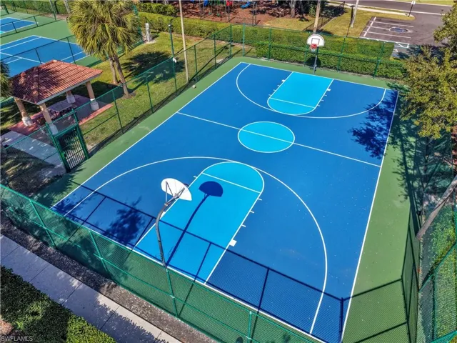 View of basketball court featuring community basketball court and a gate