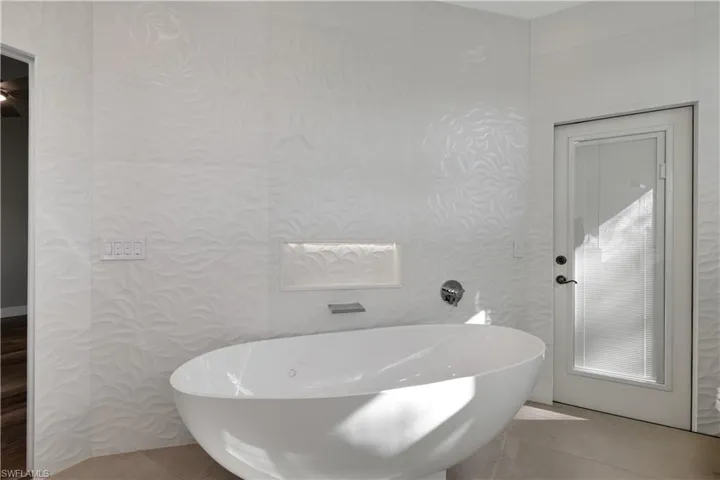 Full bathroom featuring a soaking tub