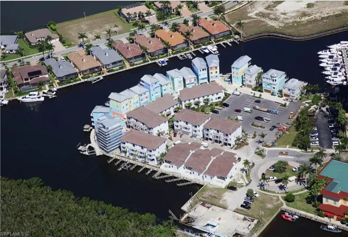 Birds eye view of property with a water view