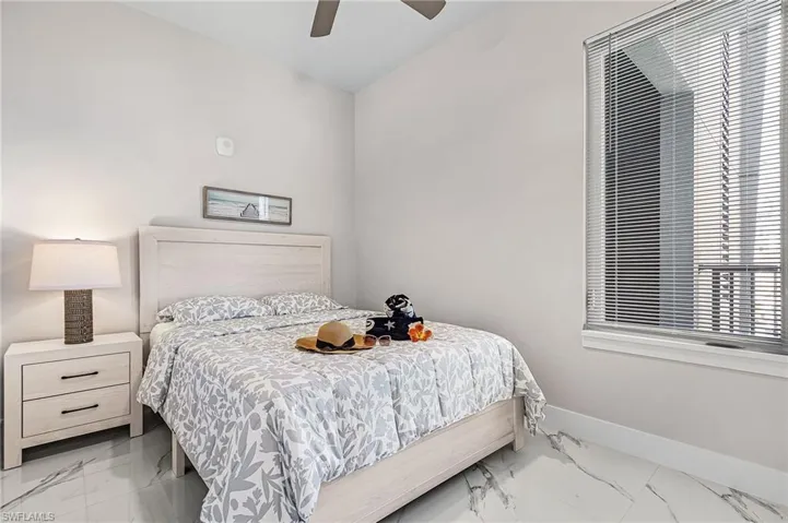 Light-toned wood-finish bed frame with matching two-drawer nightstand - Virtually Edited Image
