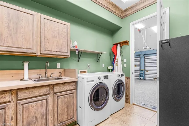 Laundry room, cabinet, sink, washer and propane dryer