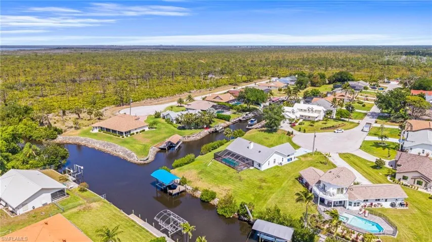 Aerial view with a forest view, a water view, and a residential view