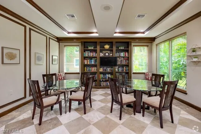 Dining room with crown molding and a tray ceiling