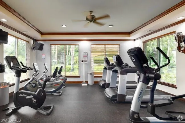 Gym with a ceiling fan, ornamental molding, and recessed lighting