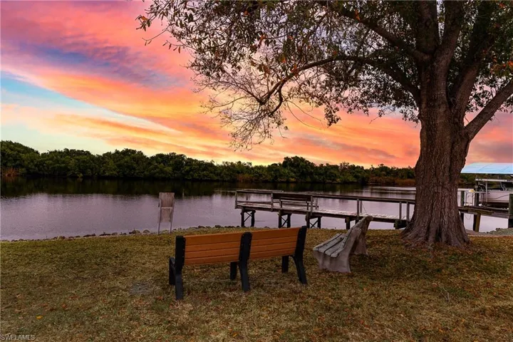 Dock with a water view and a yard