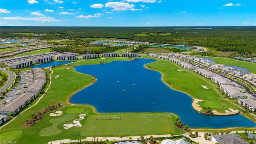 Aerial view with a water view and view of golf course