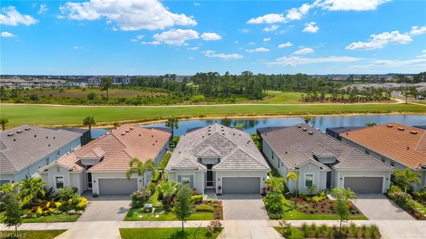 Drone / aerial view with view of golf course, a residential view, and a water view