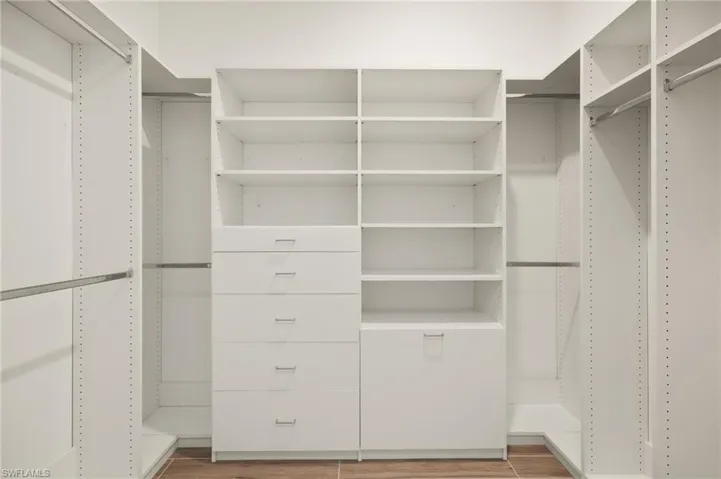 Walk in closet featuring light wood-style flooring