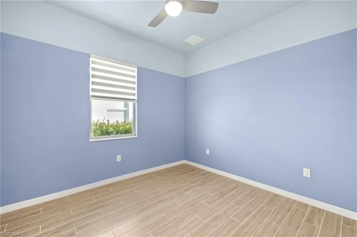 Unfurnished room featuring light wood finished floors and ceiling fan