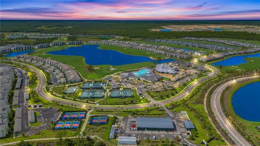 Birds eye view of property with a water view