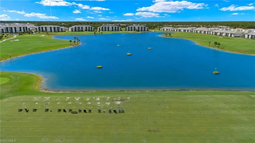 Bird's eye view with view of golf course and a water view