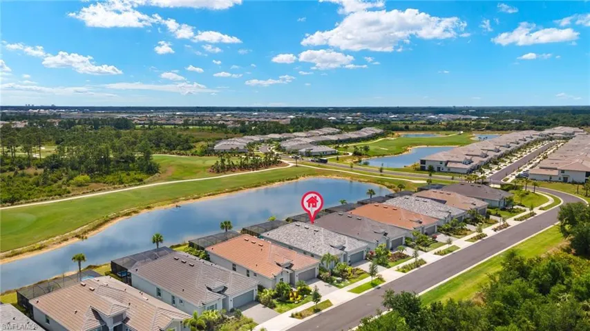 Drone / aerial view featuring a residential view, golf course view, and a water view