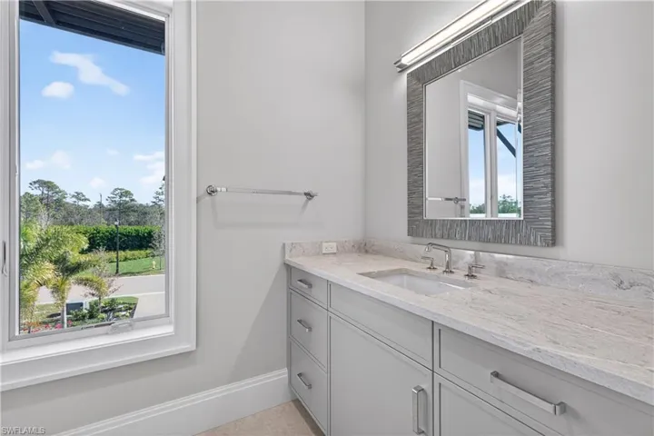 Bathroom featuring vanity and baseboards