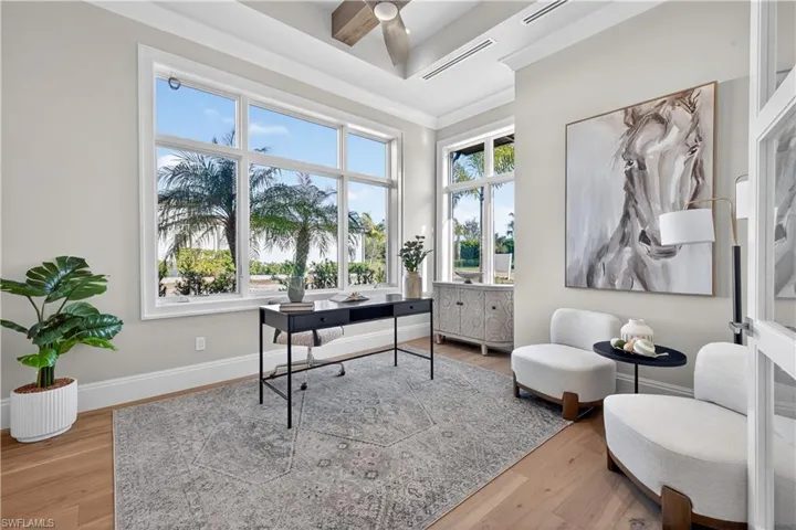 Home office with light wood-type flooring and ceiling fan