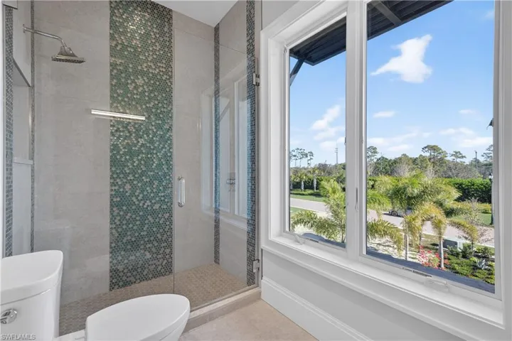 Full bath with toilet and a stall shower