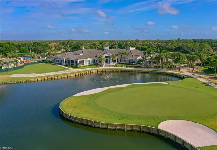 Aerial view of a golf course and a nearby body of water