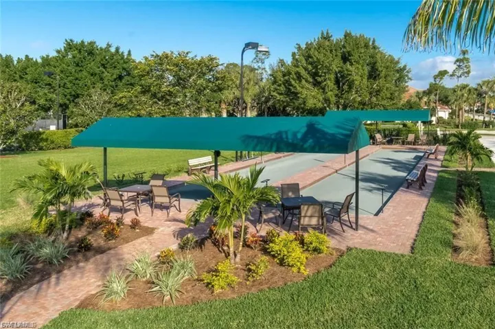 Surrounding community with a bocce ball area and a patio