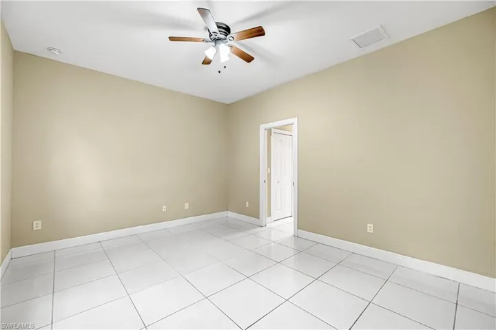 Spare room with light tile patterned floors and ceiling fan