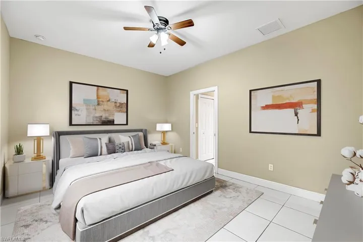Bedroom featuring light tile patterned floors and ceiling fan