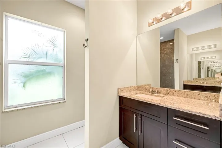 Full bath featuring light tile patterned flooring and vanity