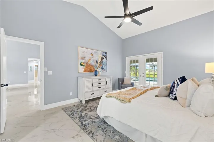 Bedroom featuring french doors, high vaulted ceiling, access to outside, marble finish floors, and baseboards